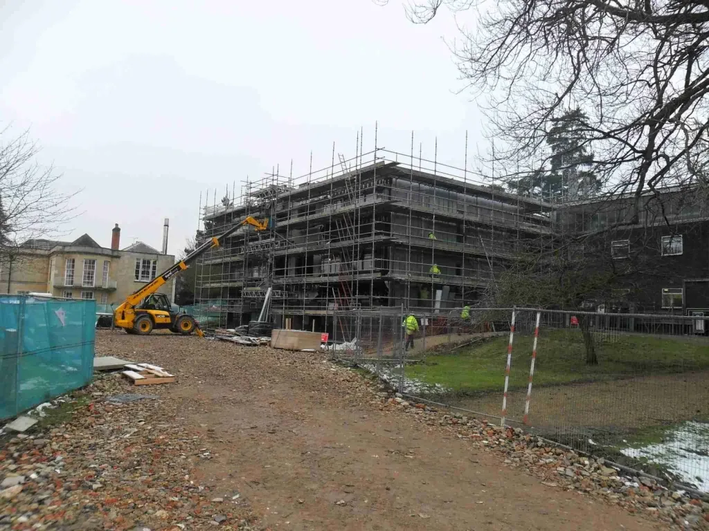 Commercial office block wrapped in tube and fitting scaffold during redevelopment